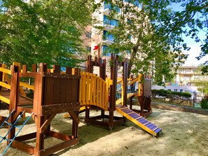 A playground with climbing structures and a slide.