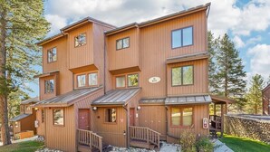 A multi-story wooden building with a stone foundation, a red door, and a small porch with steps. - Ski In-Out on 4Oclock with Chair and Town Access! (Breckenridge)