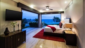 A modern bedroom with a large bed, a TV, and a view of the ocean. - Private Luxury Escape, Cabo San Lucas Villa 1048 (Cabo San Lucas)