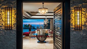A modern interior with a view of the ocean, a chandelier, and a seating area with a table and chairs. - Private Luxury Escape, Cabo San Lucas Villa 1048 (Cabo San Lucas)