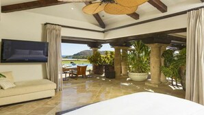 A spacious bedroom with a large bed, a TV mounted on the wall, and a view of the outdoors. - Poolside Bliss Awaits, Cabo San Lucas Villa 1006 (Cabo San Lucas)