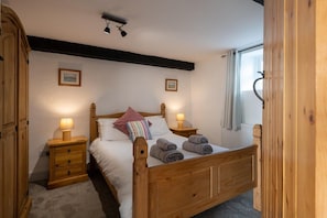 Second double bedroom with beamed ceiling in Hill Top 1, stone barn conversion sleeping six in Caergeiliog, Anglesey
