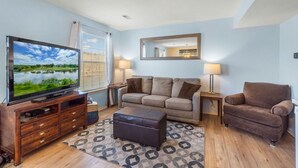 A living room with a flat-screen TV, a sofa, a loveseat, and a coffee table. - UP TO 50% OFF Lakeside Branson Condo, Incredible view, Pool, Marina (Branson)
