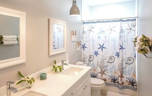 Bathtub, hair dryer, towels, soap