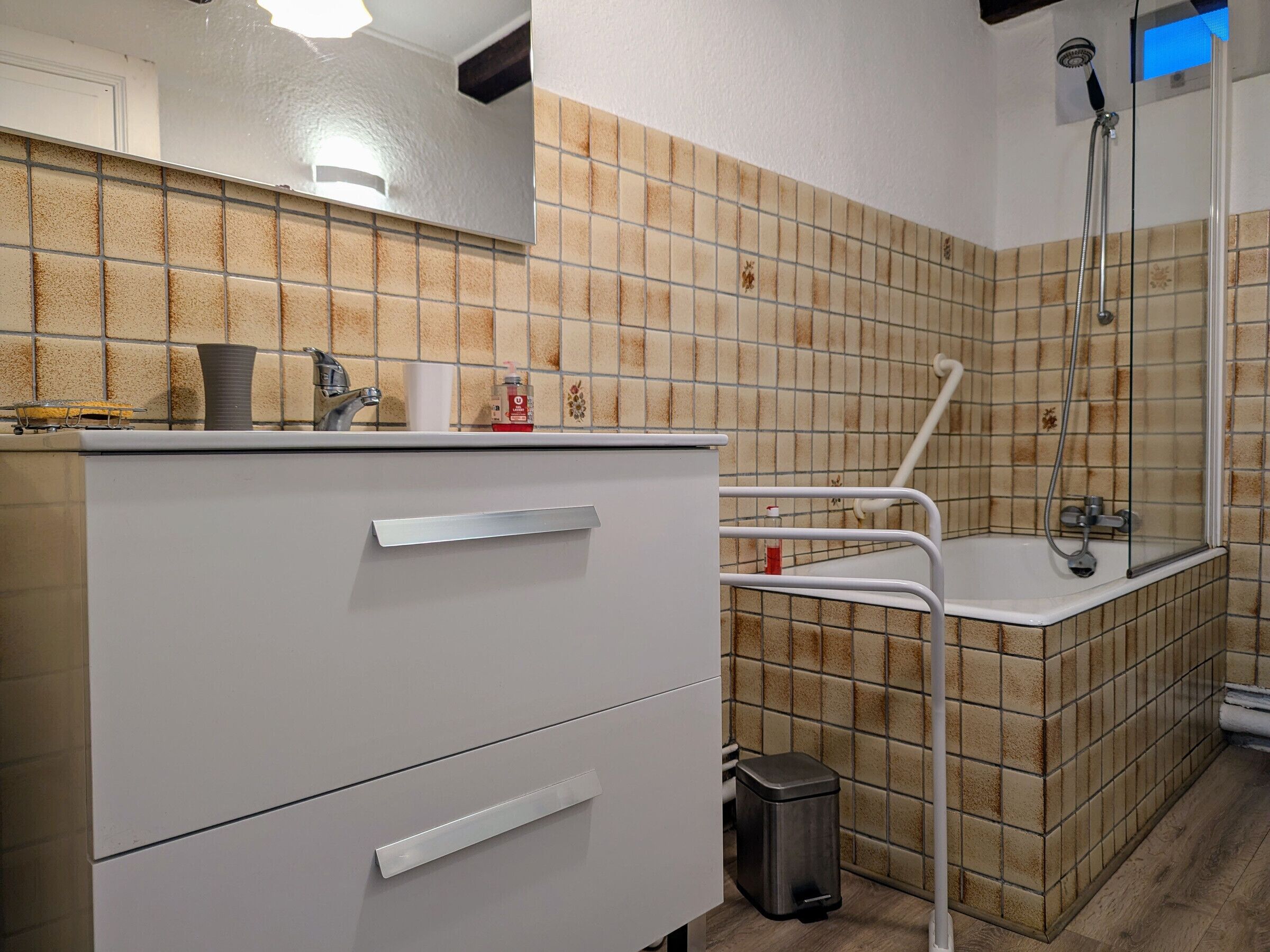 A bathroom with a shower, a sink, and a toilet.