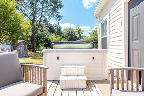 A deck with outdoor seating, a hot tub, and a wooden shed in the background. - Clean, Private Guesthouse-9 min. to Downtown Charleston, 15 min. to FollyBeach! (Charleston)