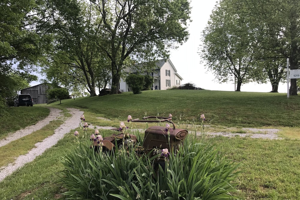 Hilltop Farmhouse with (3) sunrise and sunset porches overlooking rolling hills.