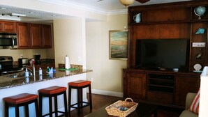 A compact living space with a kitchen, dining area, and seating. - Westwinds, paradise and heaven all rolled into one (Treasure Island)