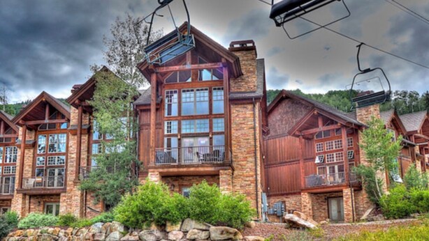 A lodge with multiple wooden cabins, stone walls, and a stone retaining wall in front. - ELKPOINT Ski-In/Out .. 4BR/4.5BA .. Sleeps 14 ..  Arcade-Shuffle Board-Foosball (Durango)