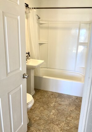 Bathtub, hair dryer, towels, soap