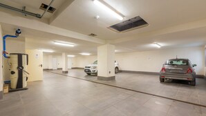 A parking garage with multiple levels, a ventilation system, and a few parked cars. - Casa Luminosa Ski in -Ski out 100m, Livigno, Italy (Livigno)