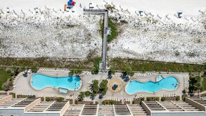 An aerial view of a resort with two swimming pools, a beach area, and a lifeguard tower. - Azure 110 walkout closest unit to beach access, no Elevator Rides! Beach Service (Fort Walton Beach)