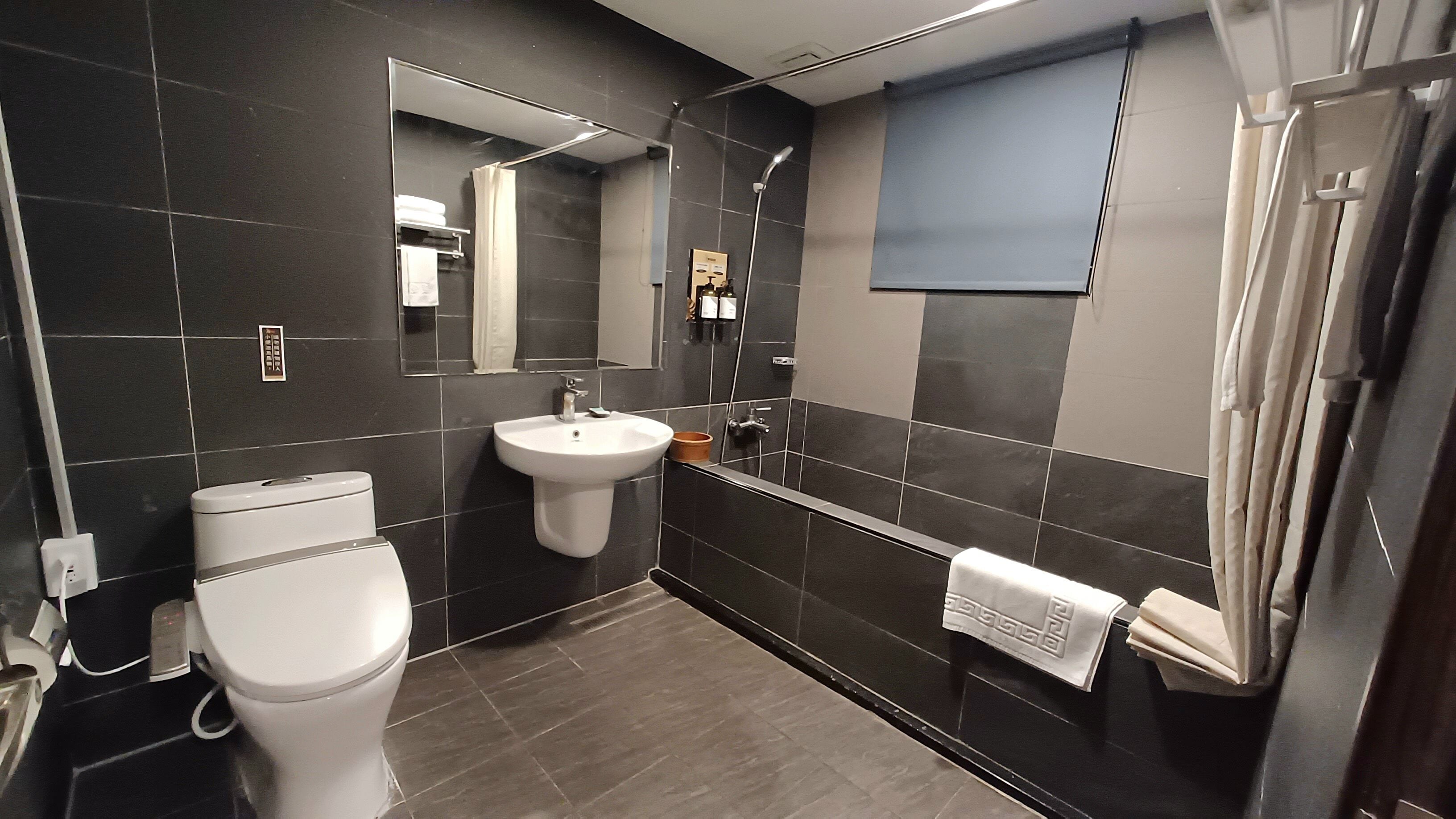 separate bathtub and shower, hair dryer, slippers, towels