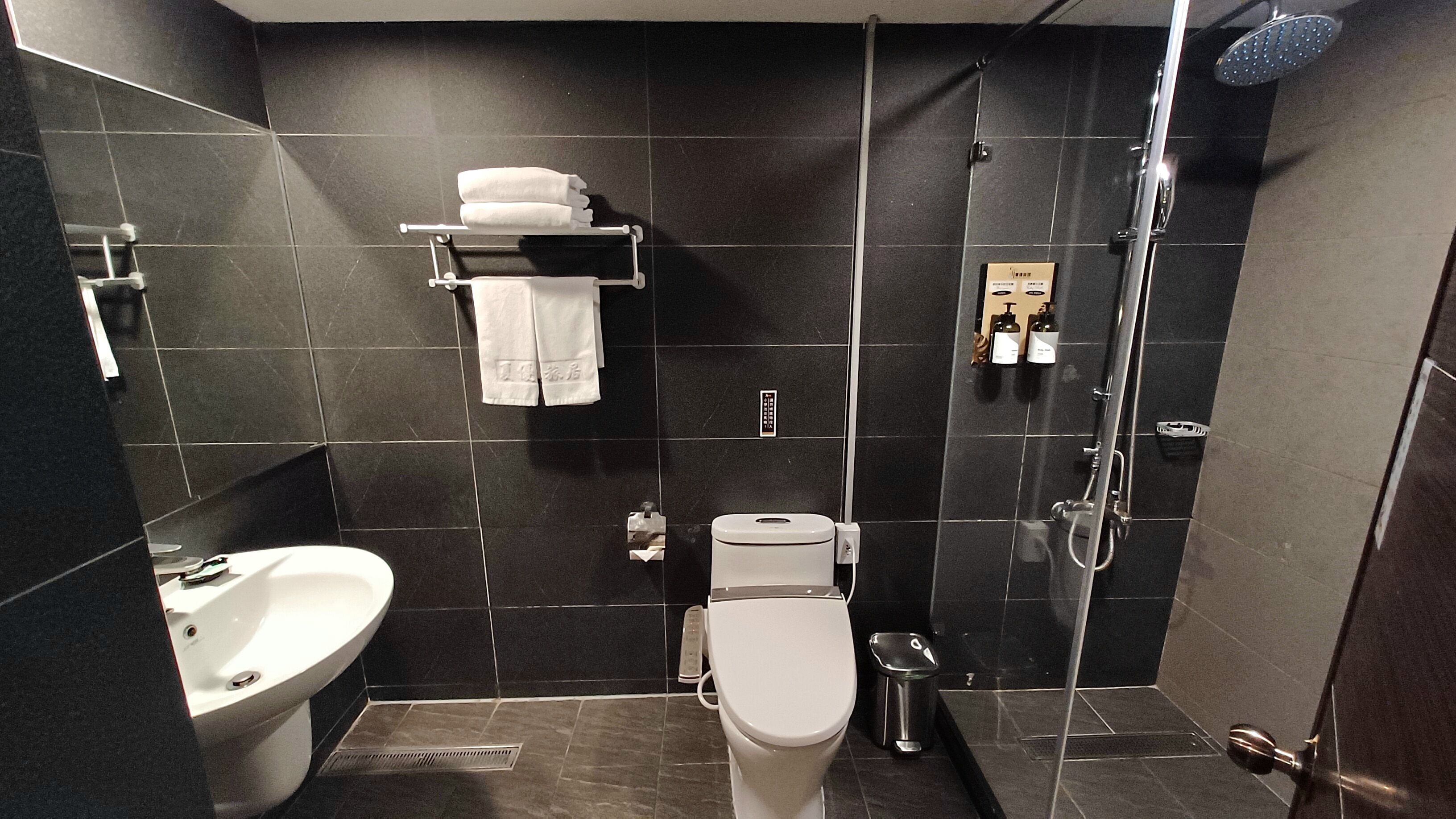 separate bathtub and shower, hair dryer, slippers, towels