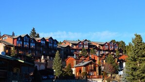 A cluster of log cabin-style buildings with multiple stories, likely part of a ski resort or mountain lodge. - 2-room cabin apartment, up to 6 people, pets allowed in Bolquère (Bolquère-Pyrénées 2000)