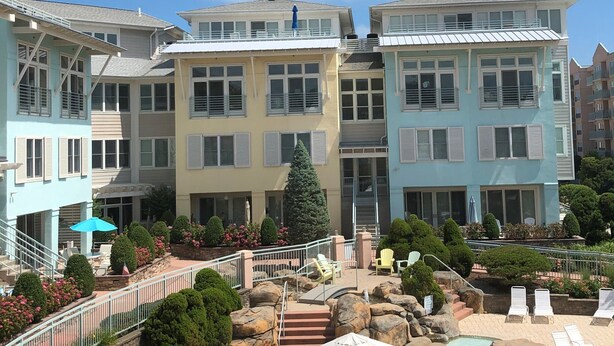 A hotel with a pool area, outdoor seating, and a view of the sky. - Modern 2 Bedrooms, 2.5 Baths in Beautiful IBIS section of Seapointe Village (Wildwood Crest)