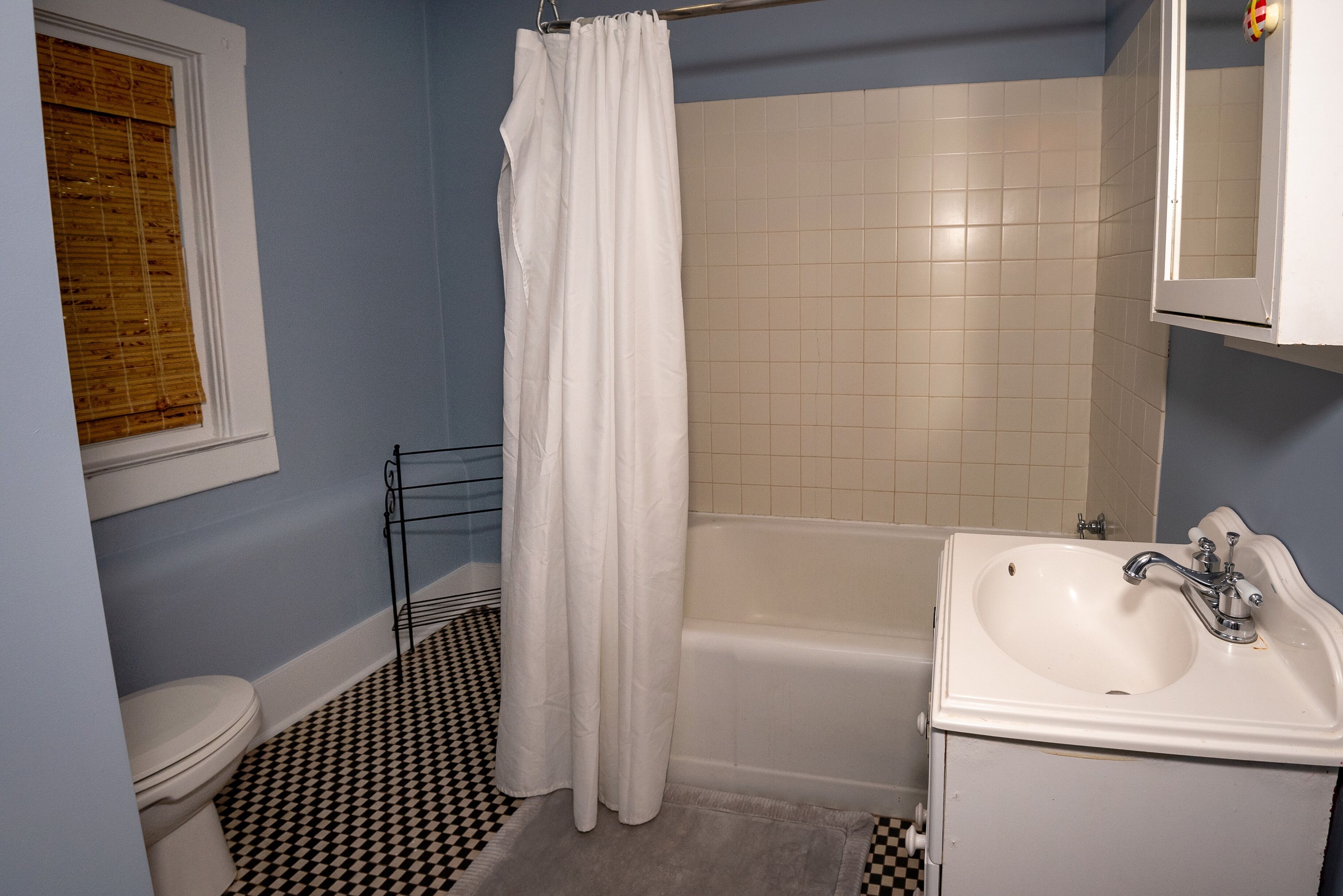A bathroom with a bathtub, a toilet, and a sink.