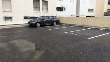 Un estacionamiento con un coche aparcado en un espacio reservado.