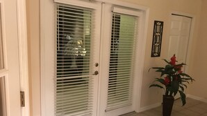 A double door with a white frame and a patterned rug at the entrance. - Beautiful Private Florida Pool Home (Cape Coral)