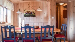 A wooden interior with a dining table, chairs, and hanging pendant lights. - Awesome home in Sjusjøen with WiFi (Sjusjøen)