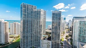 A high-rise urban area with modern glass buildings, a marina, and a clear blue sky. - ICON W BRICKELL AMAZING OCEAN VIEW 2BR/1BA (Miami)