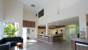 A spacious lobby with a reception desk, a sofa, and a coffee table. - Lindo Flat Localizado no Lacqua Diroma V (GO)