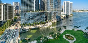 A modern high-rise hotel with a waterfront view, featuring a curved facade, multiple balconies, and a marina with boats. - ICON W BRICKELL FANCY RIVER VIEW 2BR/2BA #1904 (Miami)