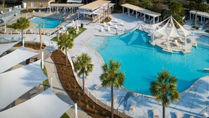 A large outdoor swimming pool with multiple sun loungers and palm trees. - PEACEFUL SEABROOK ISLAND TREEHOUSE WITH LAGOON VIEWS (Seabrook Island)