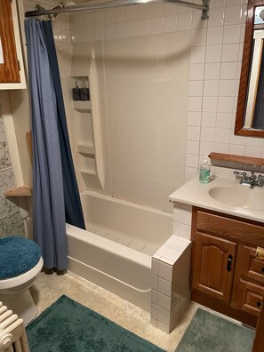 A bathroom with a bathtub, a sink, and a toilet.