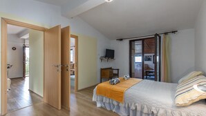 A bedroom with a bed, a television, and a window with curtains. - Awesome apartment in Klenovica with WiFi (Klenovica)
