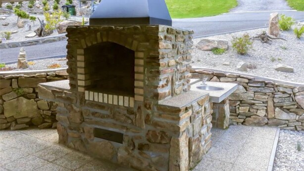 A stone-built outdoor kitchen with a built-in grill and a sink. - Nebahovy u Prachatic by Interhome (Prachatice)