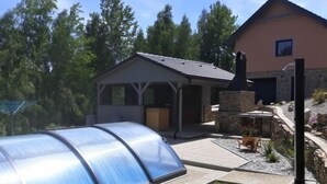 A house with a small attached garage, a covered porch, and a stone fireplace. - Nebahovy u Prachatic by Interhome (Prachatice)