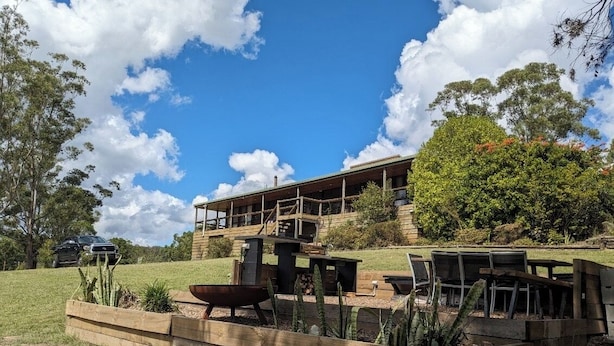 A wooden deck with outdoor furniture, a barbecue grill, and a large planter with cacti. - Bush Farm overlooking quiet valley  (Clarence Town)