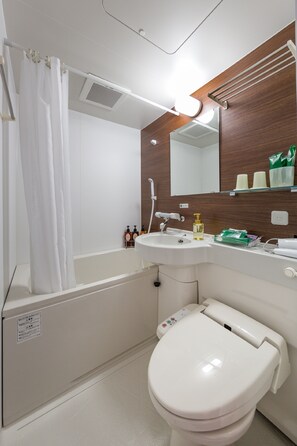 A modern bathroom with a bathtub, toilet, and sink. - Hotel Route Inn Kusatsuritto Rittointer -Ritto inter Kokudo 1gou (Ritto)