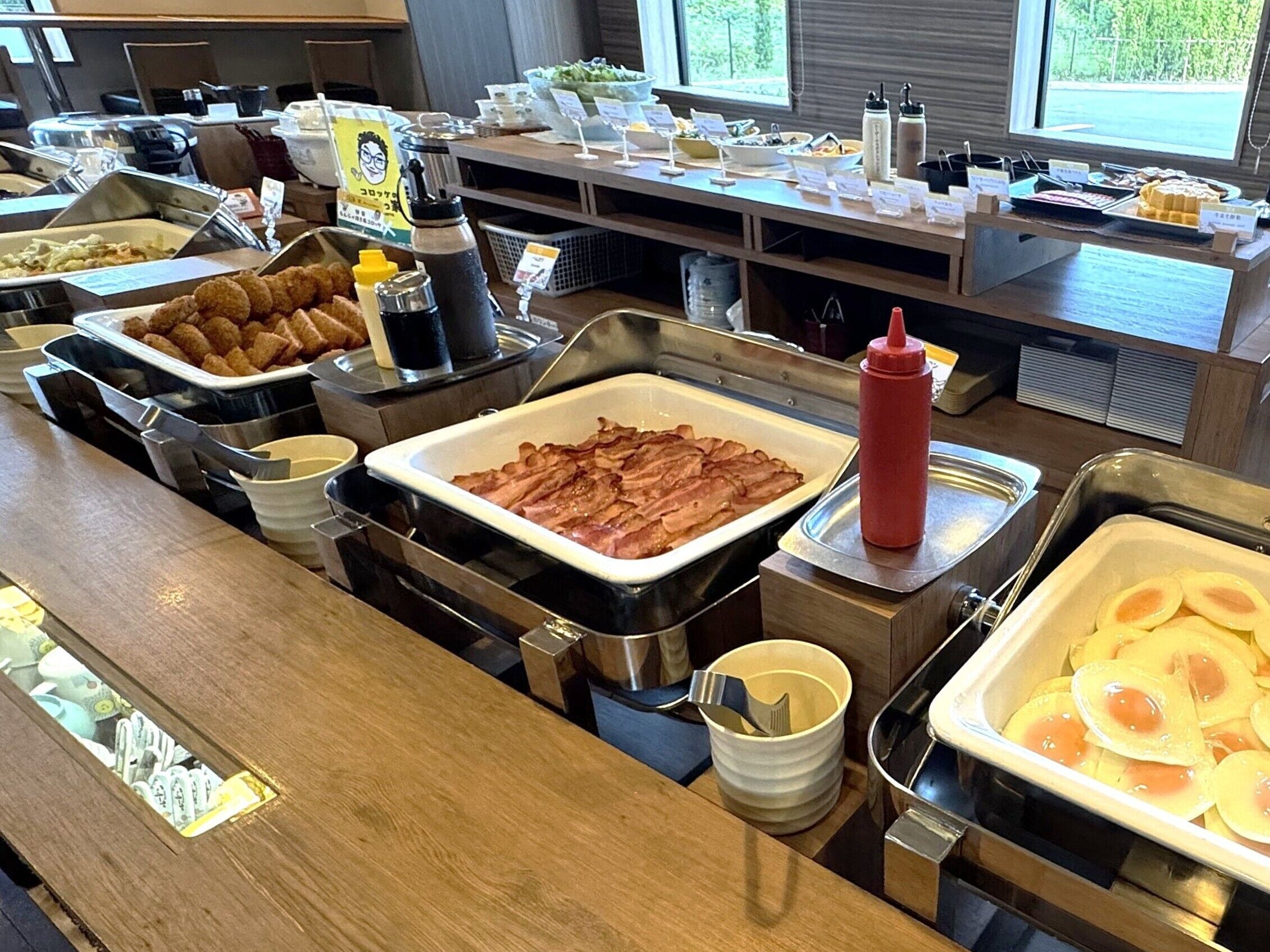 A buffet with various food items and condiments.