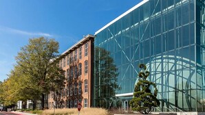 A modern building with large glass windows and a brick facade.