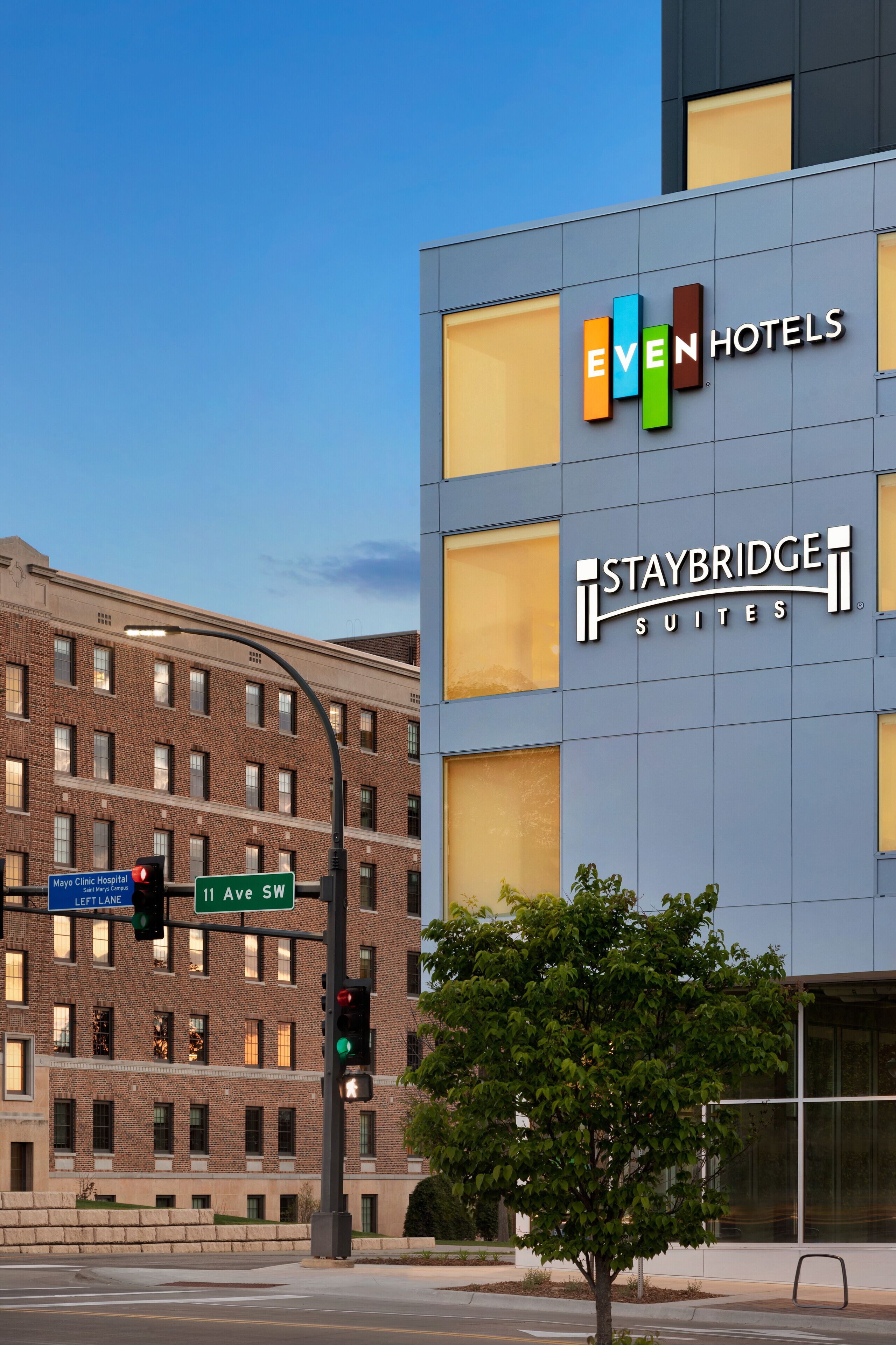 A modern hotel building with the Staybridge Suites logo, located at 11 Ave SW.