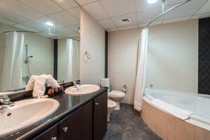 Une salle de bain moderne équipée d’un meuble-lavabo à deux vasques, de toilettes, d’une baignoire et d’une douche.