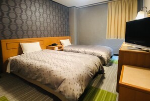 A hotel room with two beds, a television, a desk, and a lamp. - Urban Place Inn Kokura (Kitakyushu)