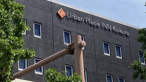 Un bâtiment sur lequel on peut lire l’inscription : « Urban Place INN Kokura ».