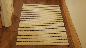 Una habitación con suelo de madera, un futón de tatami y un biombos shoji.