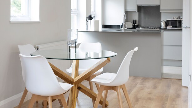 A modern kitchen with white cabinets, a stainless steel sink, and a microwave. - 2 Bedroom Apartment near Town Center (Reading)