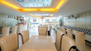 A restaurant interior with booths and a counter. - OYO 75362 Swagath Home (Bangkok)