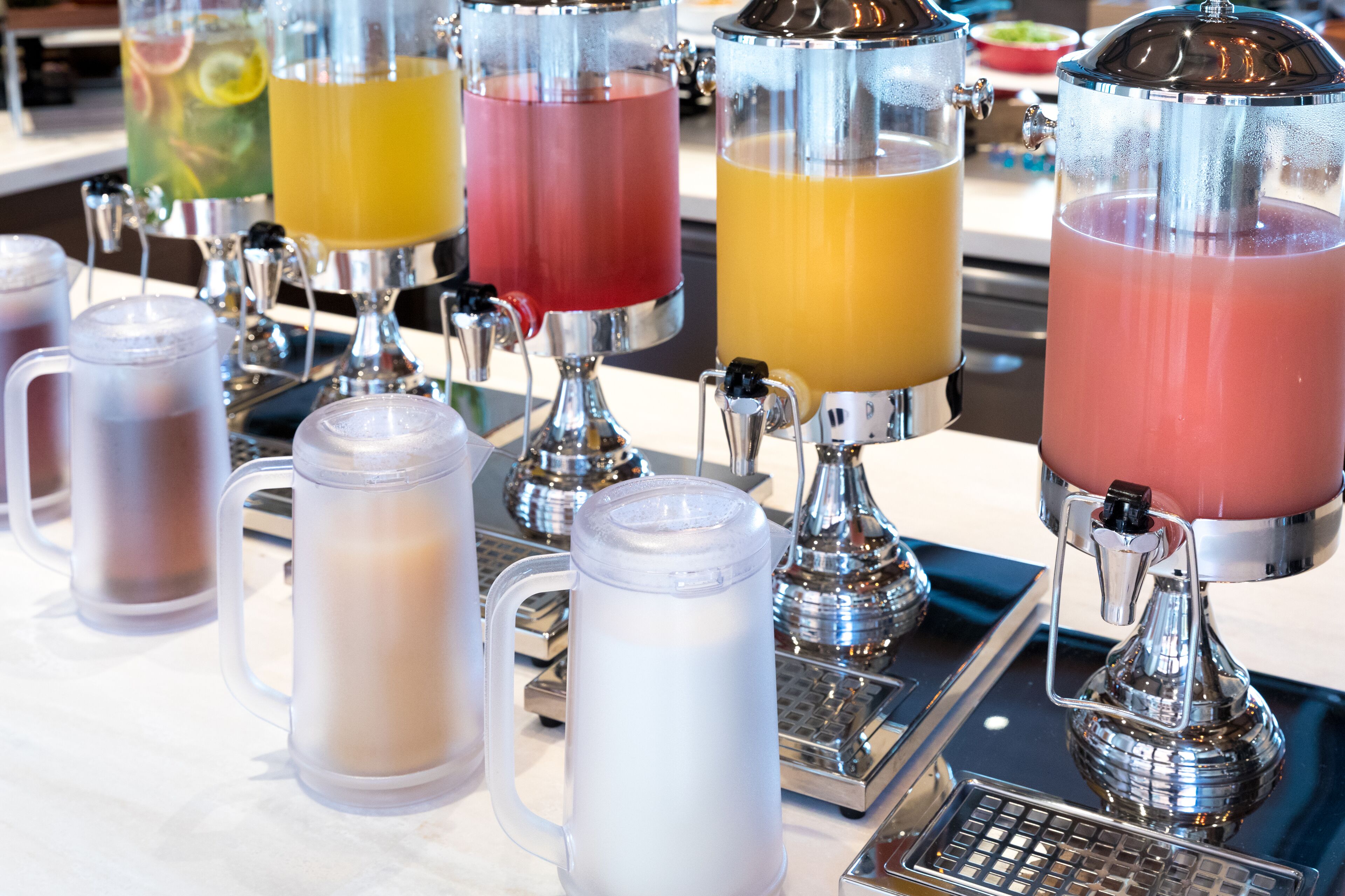 A bar area with multiple beverage dispensers and a coffee machine.
