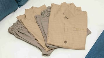 A neatly folded set of beige trousers with a label on one.