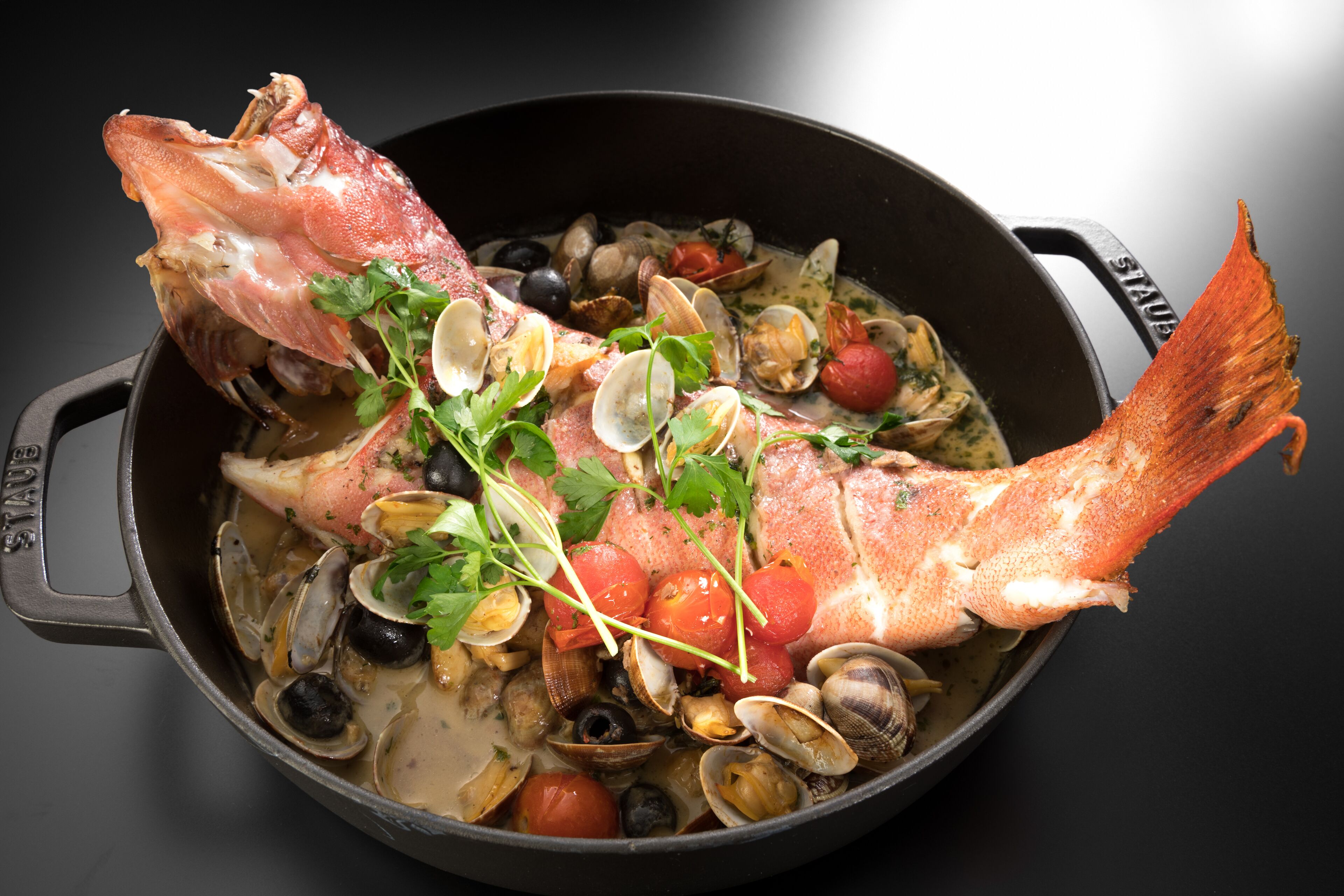 A seafood dish in a pot.