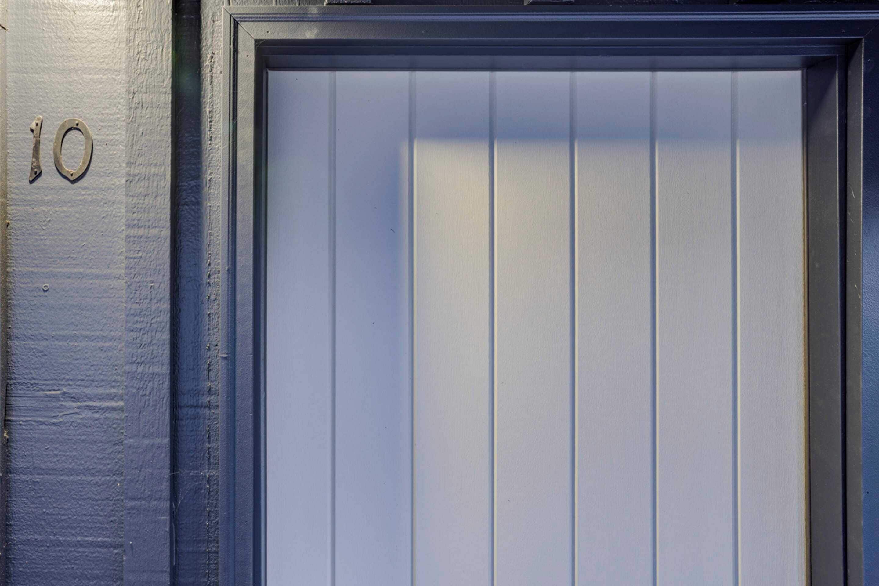A closed door with a number '10' on the wall beside it.