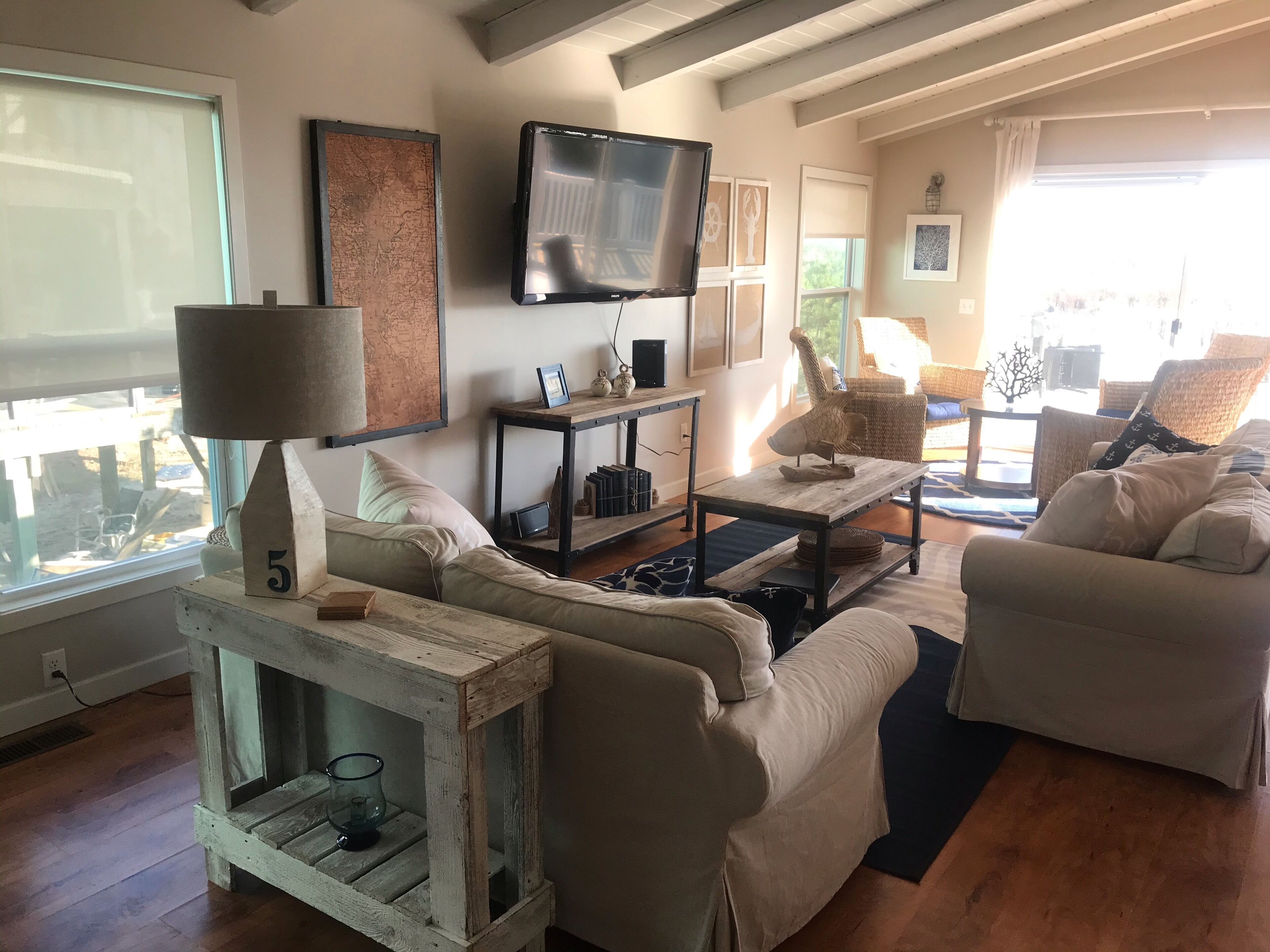 A living room with two sofas, a coffee table, a TV, and a bookshelf.