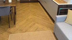 A compact kitchen with modern appliances, a dining area with a table and chairs, and a cozy seating area with a sofa. - Unique 1 bedroom in Reading (Reading)