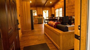 A wooden interior with a reception desk, a kitchen area, and a dining table. - Old World Craftmanship with Modern Amenities (Bristol)